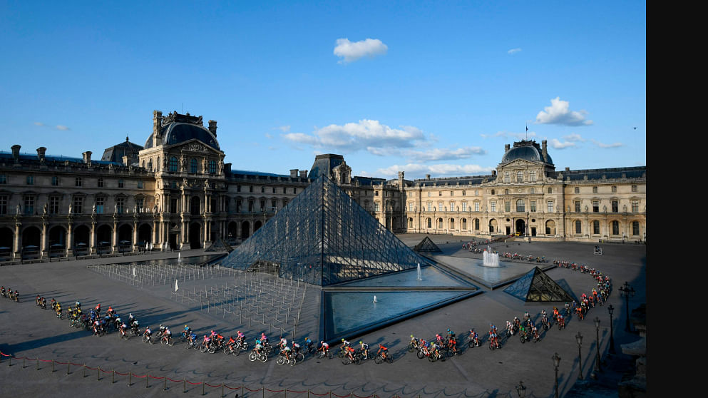 The peleton rides past the pyramid of The Louvre Museum designed by Ieoh Ming Pei during the twenty-first and final stage of the 106th edition of the Tour de France cycling race between Rambouillet and Paris Champs-Elysses in Paris on 28 July 2019. AFP File Photo