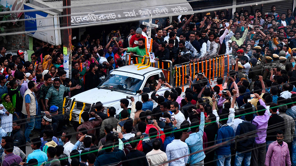 People gather as the body of Sam Stafford, 18, who was killed after police fired during a protest against the government`s Citizenship Amendment Bill (CAB) a day before, is carried on a vehicle for cremation, in Guwahati on 13 December 2019. Photo: AFP