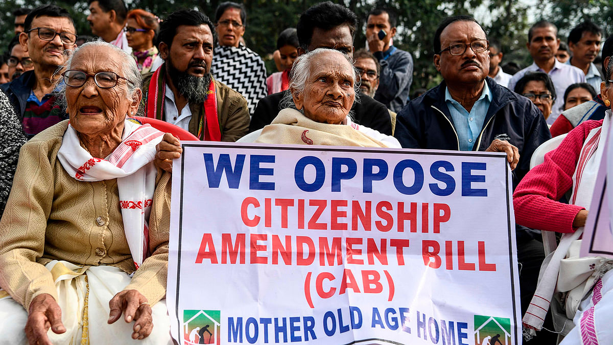 Demonstrators hold placards during a protest against the government`s Citizenship Amendment Bill (CAB) in Guwahati on 13 December 2019. Photo: AFP