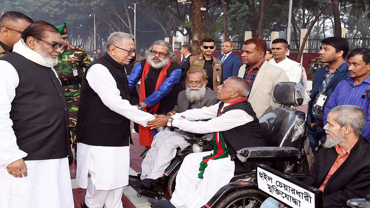 President Abdul Hamid talks to the war-wounded freedom fighters and enquires about their wellbeing after paying respect to the martyred intellectuals on the occasion of Martyred Intellectuals Day at the Martyred Intellectuals Memorial in Mirpur, Dhaka on 14 December 2019. Photo: PID