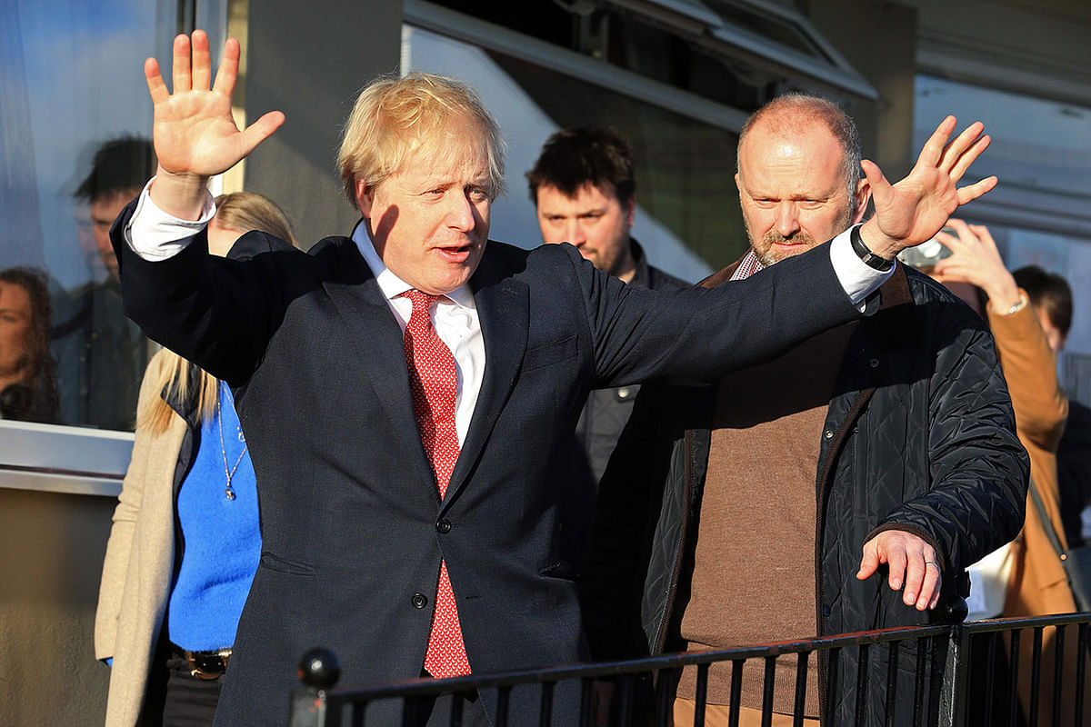 Britain`s prime minister Boris Johnson gestures during a visit to newly elected Conservative party MP for Sedgefield, Paul Howell at Sedgefield Cricket Club in County Durham, north east England on 14 December, following his Conservative party`s general election victory. Photo: AFP