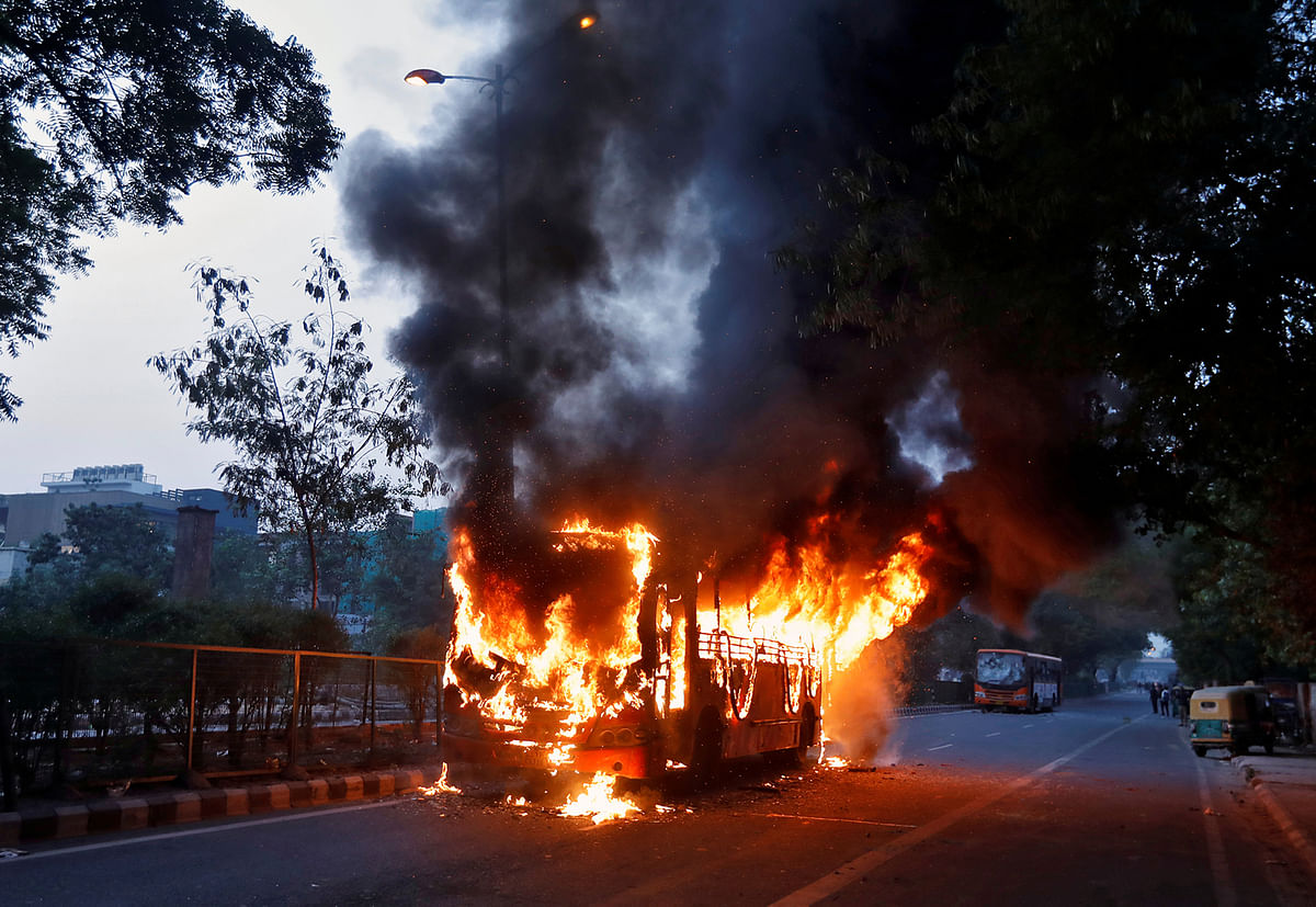 A passenger bus burns after it was set on fire by demonstrators during a protest against a new citizenship law, in New Delhi, India on Sunday. Photo: Reuters