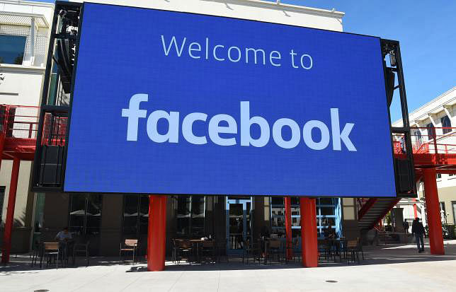 In this file photo taken on 23 October 2019 a giant digital sign is seen at Facebook`s corporate headquarters campus in Menlo Park, California. Digital services company Cognizant on 31 October 2019 said it will stop its work to help filter vile content posted at online venues such as Facebook. Photo: AFP