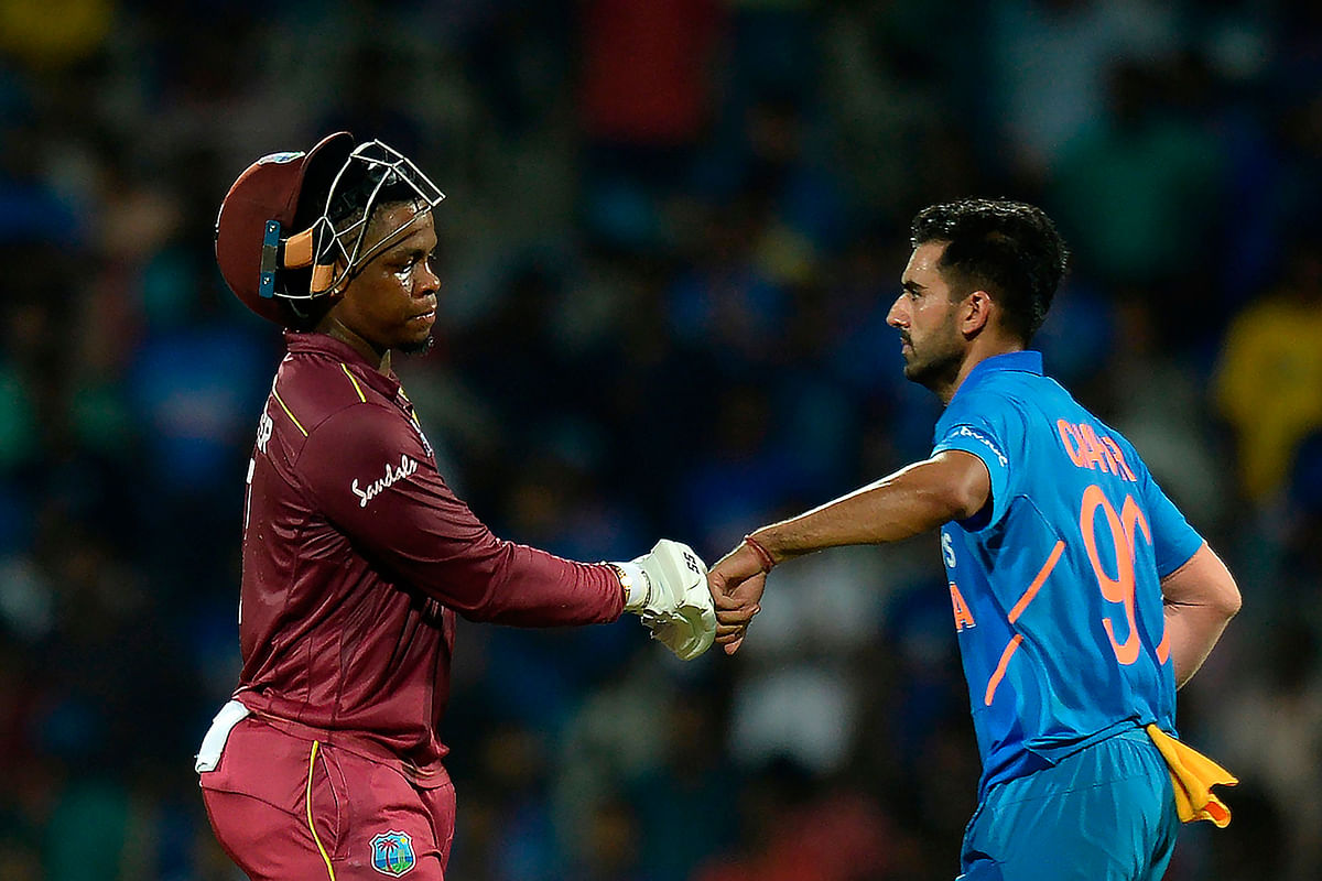 West Indies` Shimron Hetmyer (L) gestures along with India`s Deepak Chahar as he walks back to the pavilion after he got caught during the first one day international cricket match of a three-match series between India and West Indies, at the M.A. Chidambaram Cricket Stadium in Chennai on Sunday. Photo: AFP