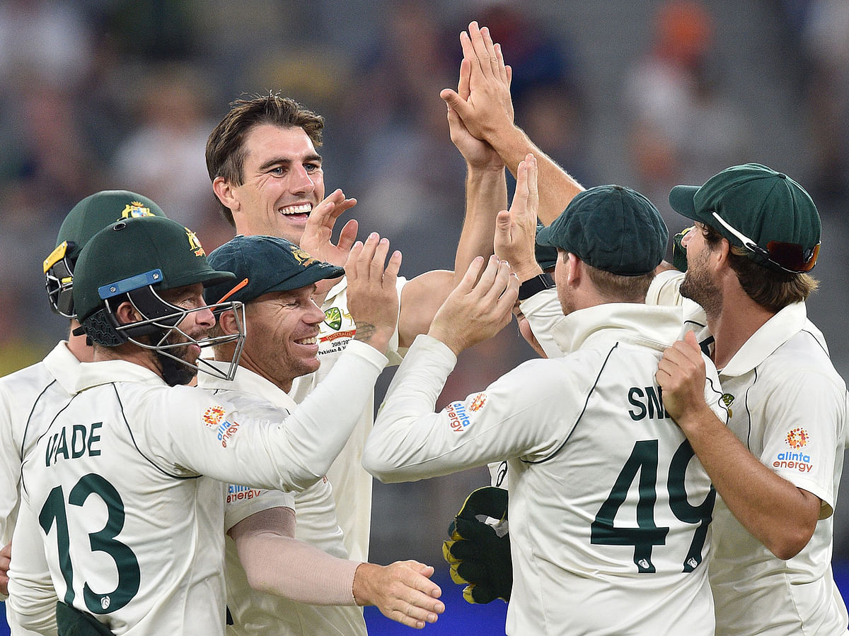 Australia`s Pat Cummins (centre L) celebrates the wicket of New Zealand`s Colin de Grandhomme on day four of the first Test cricket match between Australia and New Zealand at the Perth Stadium in Perth on 15 December 2019. Photo: AFP