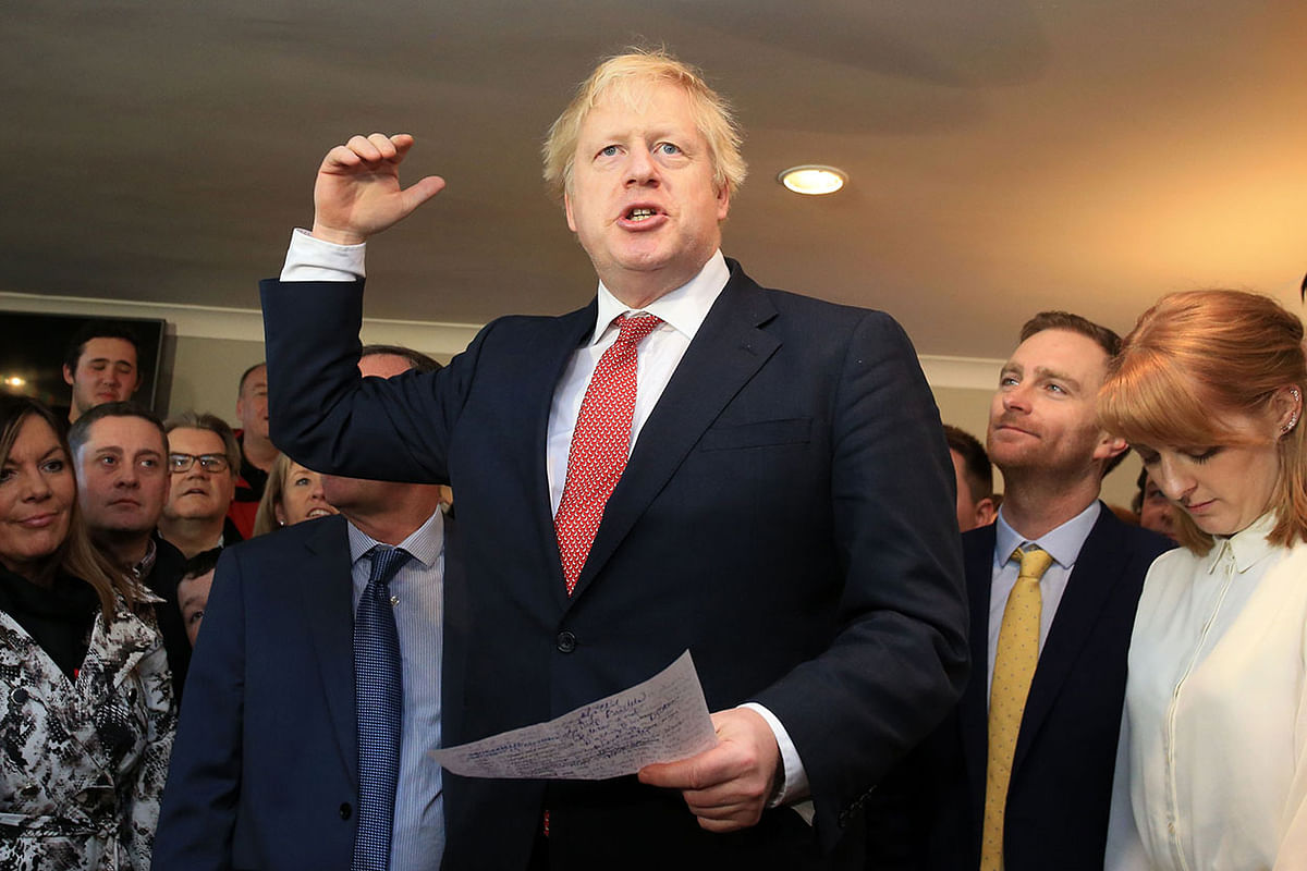 Britain`s prime minister Boris Johnson gestures as he speaks to supporters on a visit to meet newly elected Conservative party MP for Sedgefield, Paul Howell at Sedgefield Cricket Club in County Durham, north east England on 14 December 2019, following his Conservative party`s general election victory. Photo: AFP