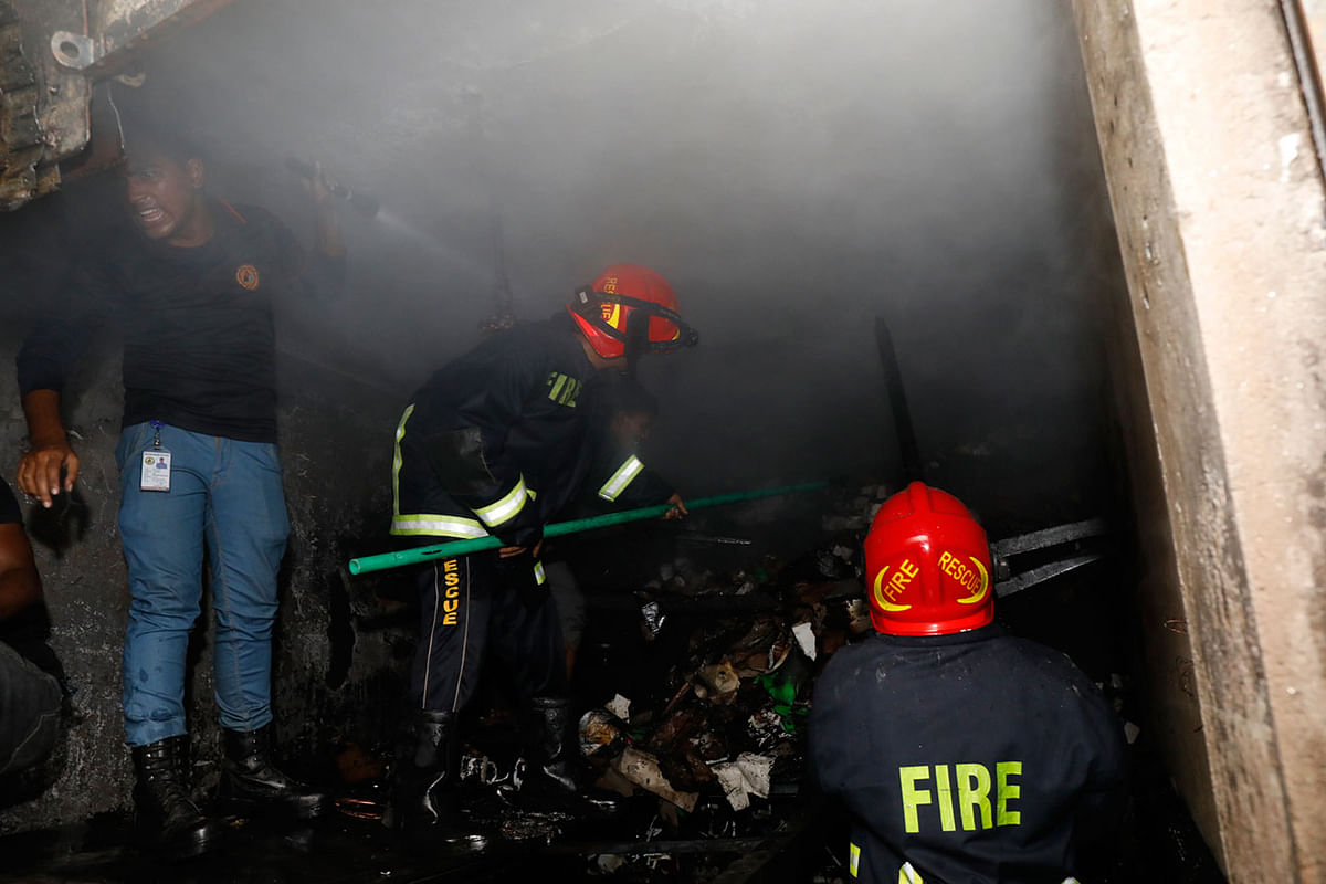 Fire service men douse a fire at a market in Katabon in Dhaka on 15 December 2019. Photo: Dipu Malakar