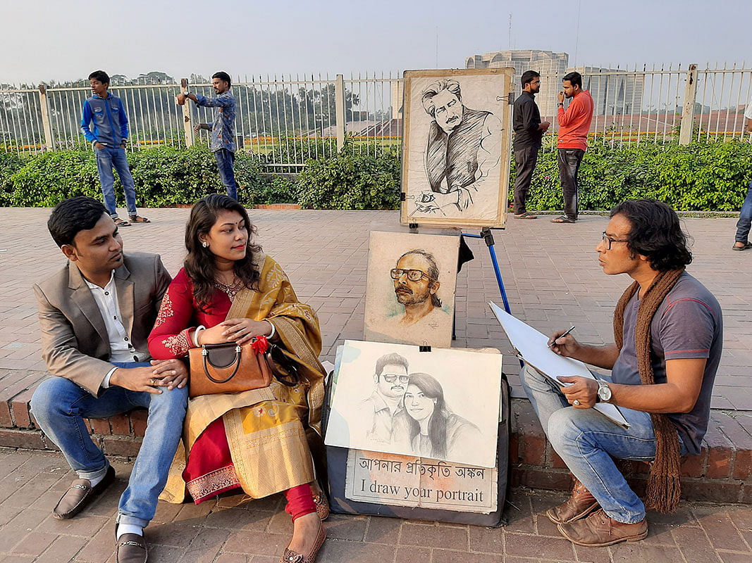 A couple poses for a sketch in front of the Jatiya Sangsad Bhaban in Dhaka on 15 December 2019. Photo: Mansura Hossain