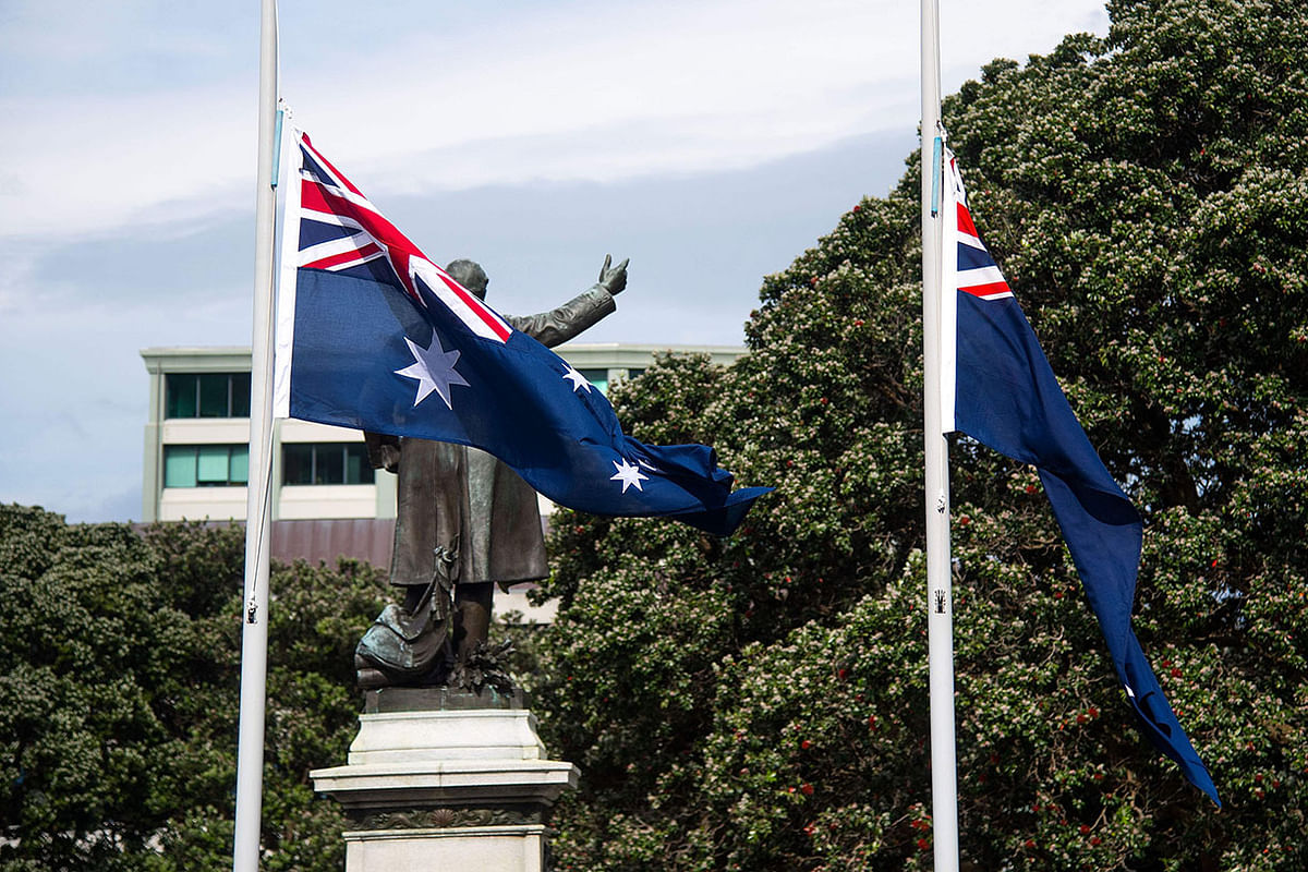 A New Zealand flag (R) flies at half mast alongside an Australian flag (L) in respect for victims of the 9 December White Island volcanic eruption, at Parliament in Wellington on 16 December 2019. Photo: AFP