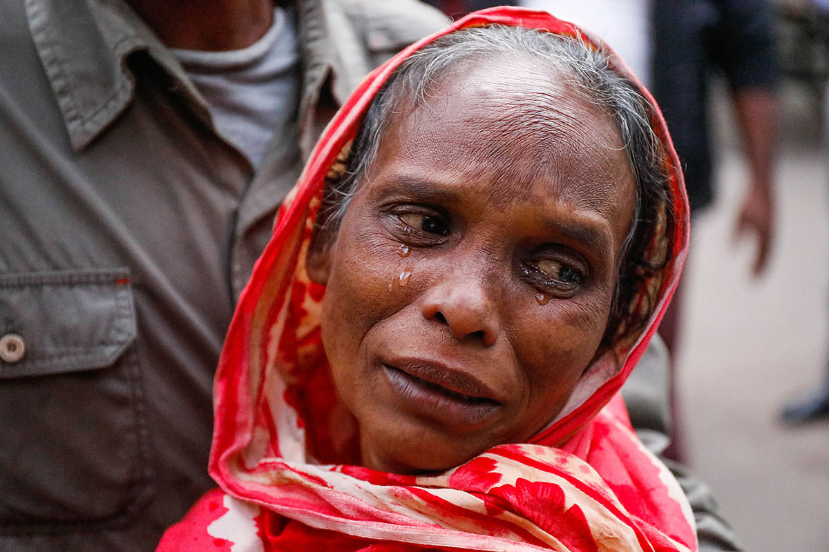 A woman at Dhaka Medical College and Hospital in Dhaka on 15 December 2019 breaks into tear as she collects the body of her son who was killed in a deadly factory fire at Keraniganj on 11 December. Photo: Dipu Malakar