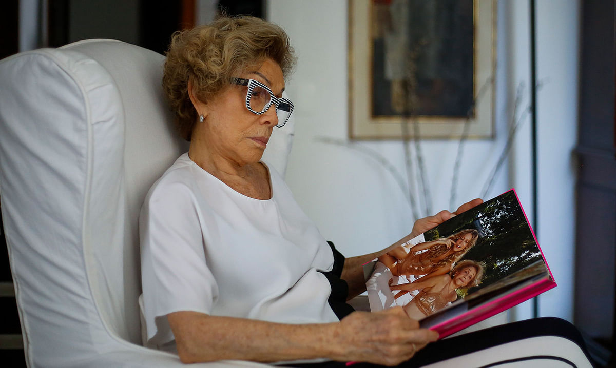 Brazilian fashion designer and model Helena Schargel, 79, looks at a magazine during an interview with AFP in Sao Paulo, Brazil, on 1 November 2019. Helena Schargel designs lingerie for senior women. Photo: AFP