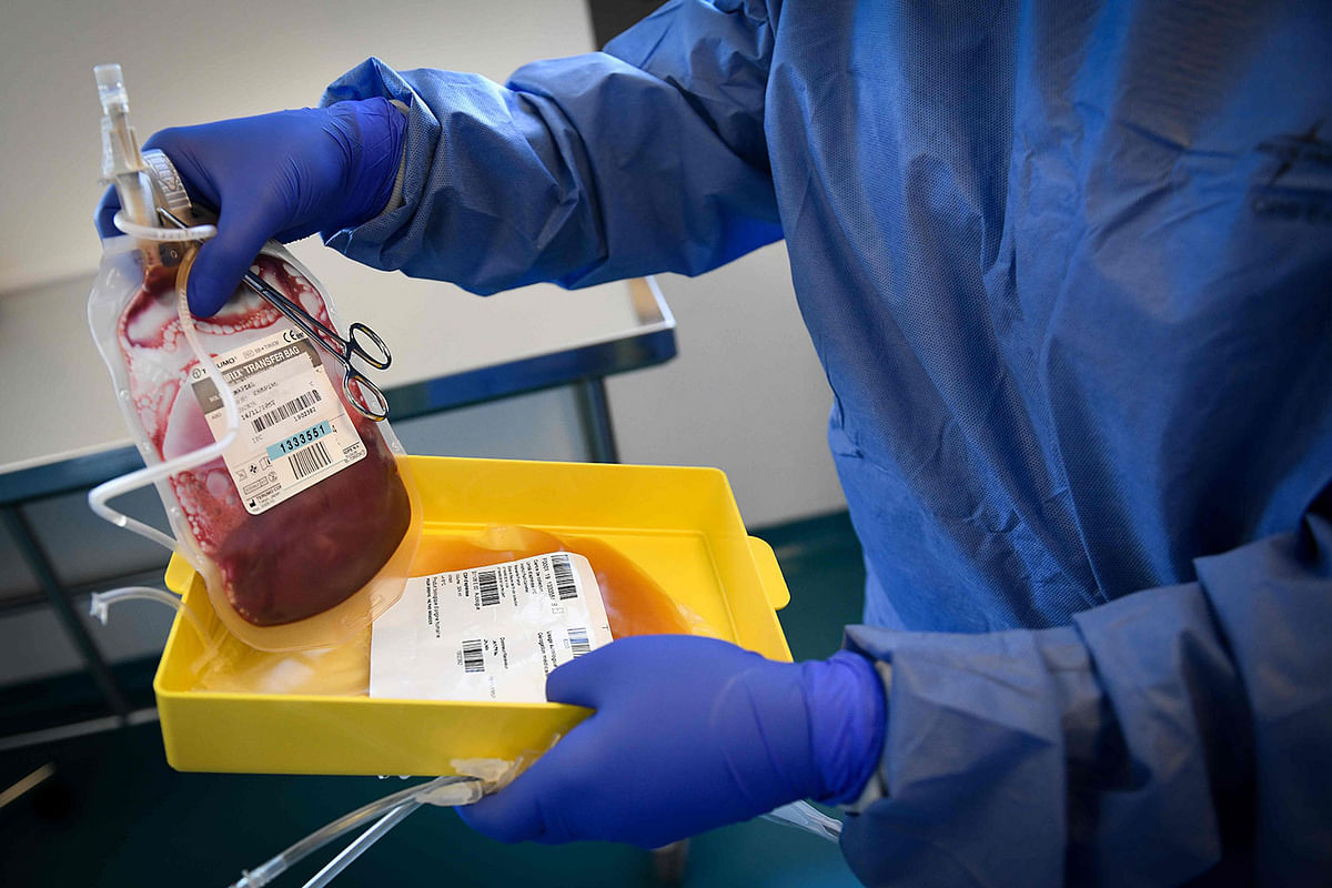In this file photo taken on 8 March 2019, a lab tech handles blood after it passed through a laboratory centrifuge before genetically modifying a patient’s immune cells at a production laboratory unit of the Paoli-Calmettes Institute (IPC) overall cancer care centre in Marseille, France. Photo: AFP