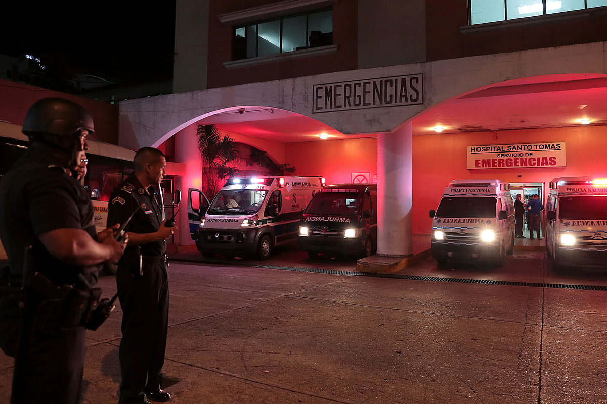 Police officers keep watch outside a hospital where injured inmates were taken following a shootout among inmates at La Joyita prison, in Panama City, Panama on 17 December. Photo: Reuters