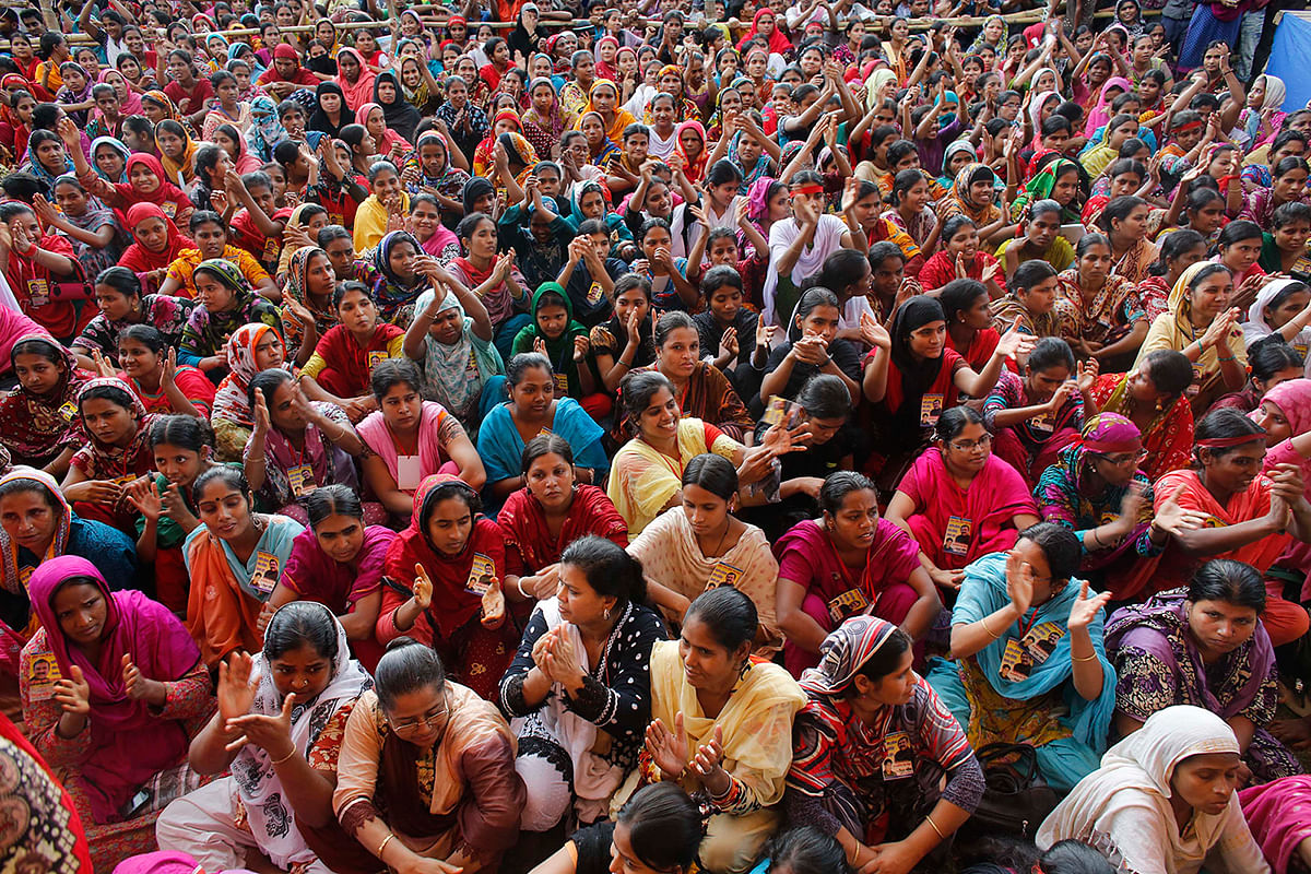 Garment workers listen to speakers during a rally demanding an increase to their minimum wage in Dhaka on 21 September 2013. Photo: Reuters