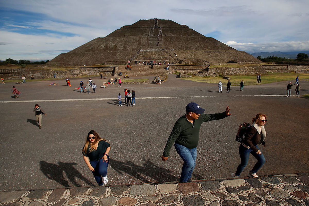 Tourists are seen during a visit to the ancient city of Teotihuacan, with the Pyramid of the Sun in the background, in San Juan Teotihuacan. Photo: Reuters