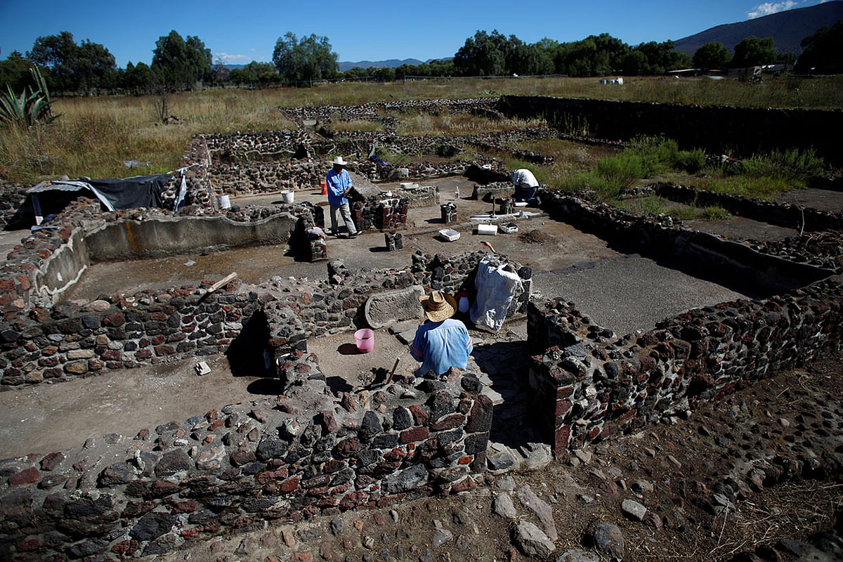 Men work at one of the multi-family apartment compounds at La Ventilla, one of the most extensively excavated neighborhoods in the ancient city of Teotihuacan, in San Juan Teotihuacan. Photo: Reuters