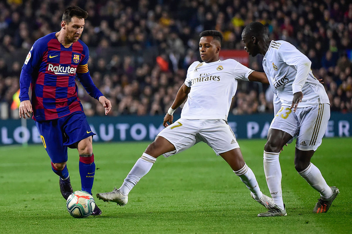 Barcelona`s Argentine forward Lionel Messi (L) vies with Real Madrid`s Brazilian forward Rodrygo (C) and Real Madrid`s French defender Ferland Mendy (R) during the `El Clasico` Spanish League football match at the Camp Nou Stadium in Barcelona on 18 December 2019. Photo: AFP