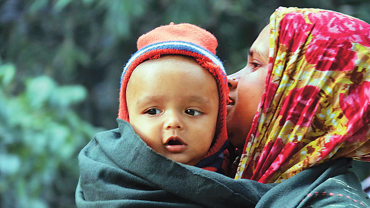 A woman wraps her grandson in a shawl to keep him warm from mild cold wave that sweeps over parts of Bangladesh. Moinul Islam takes this photo at Nilkantha area, Rangpur on 18 December.