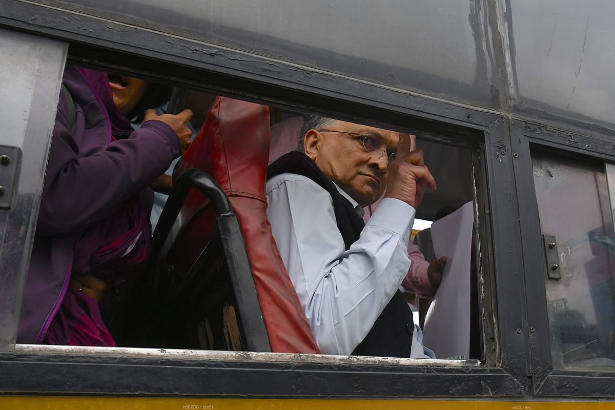 Historian Ramchandra Guha flashes the victory sign from a bus after being taken into custody by police at the Town Hall during a protest held against India`s new citizenship law in spite of a curfew in Bangalore on 19 December 2019. Photo: AFP