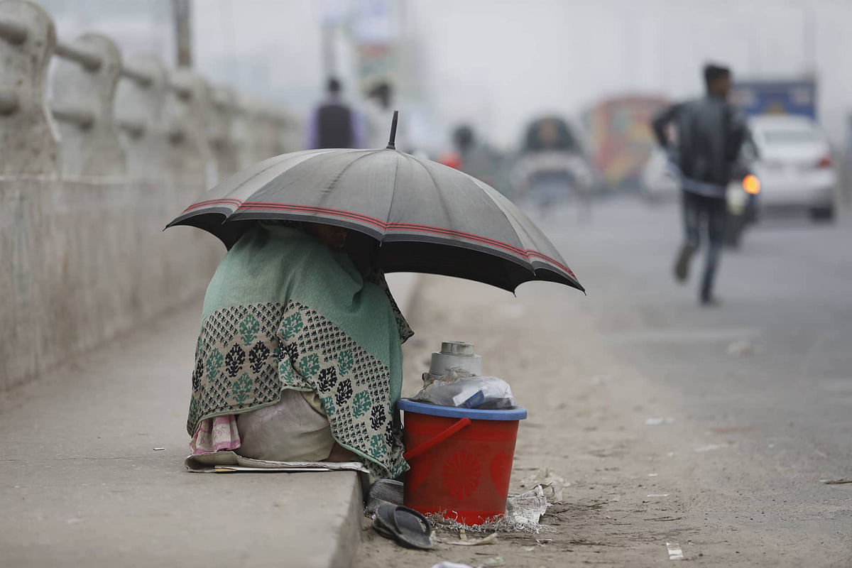 People suffer in cold wave that sweeps over parts of Bangladesh. Dipu Malakar takes this photo from Babubazar area, Dhaka on 19 December.