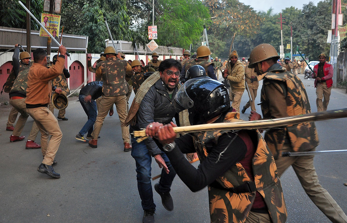 Police officers wield sticks against demonstrators during a protest against a new citizenship law, in Lucknow, India, on 19 December 2019. Photo: Reuters