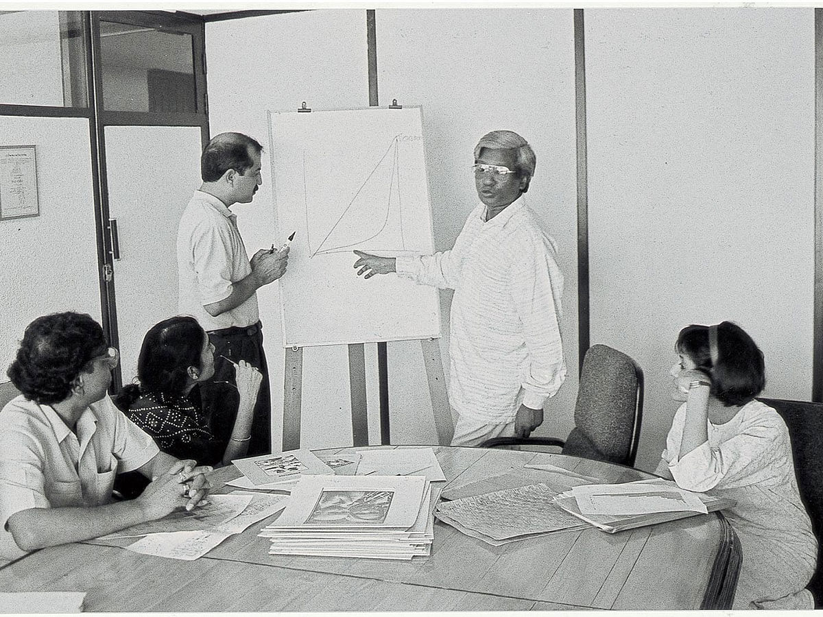 Sir Fazle Hasan Abed works with colleagues. Photo: BRAC