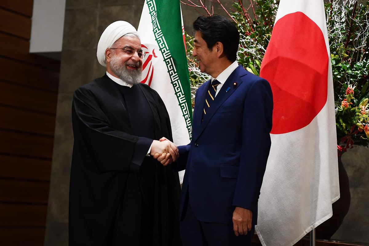 Iranian president Hassan Rouhani (L) shakes hands with Japanese prime minister Shinzo Abe (R) before a meeting at the prime minister`s office in Tokyo on 20 December 2019. Photo: AFP
