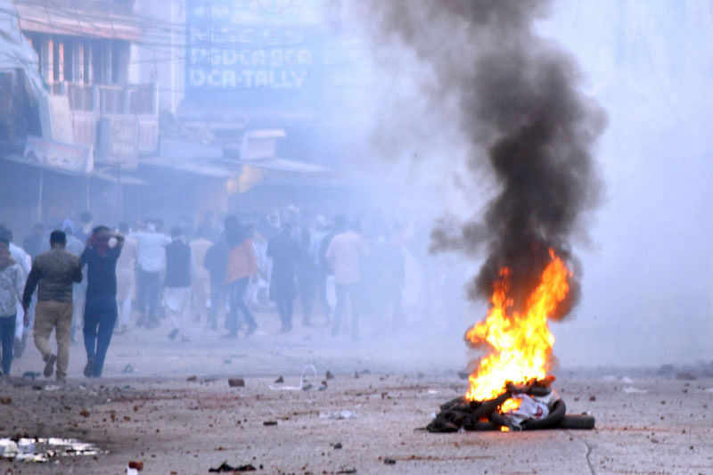 In this photograph taken on 20 December 2019, a fire burns as protesters take part in a rally against India`s new citizenship Law in Jabalpur. Photo: AFP