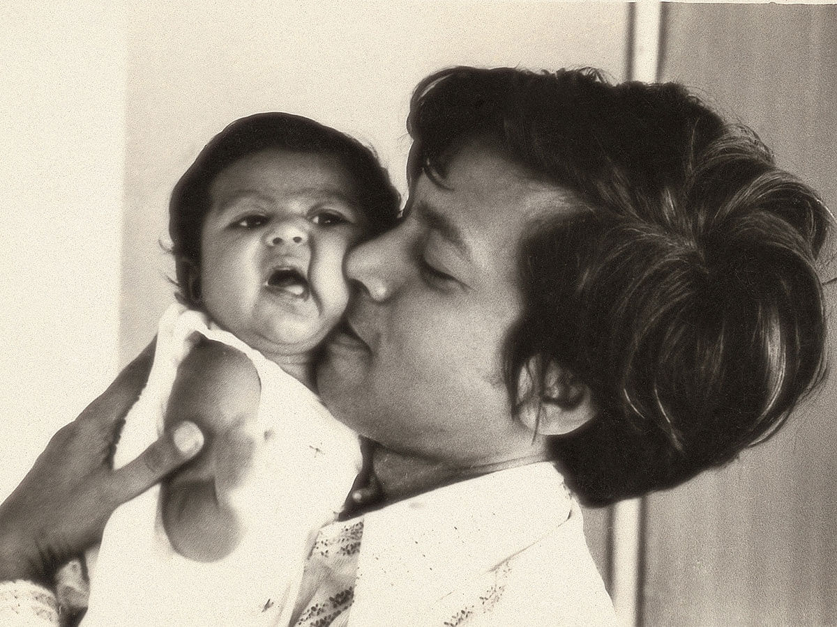This photo taken from Sir Fazle Hasan Abed`s family album shows him caressing a child.