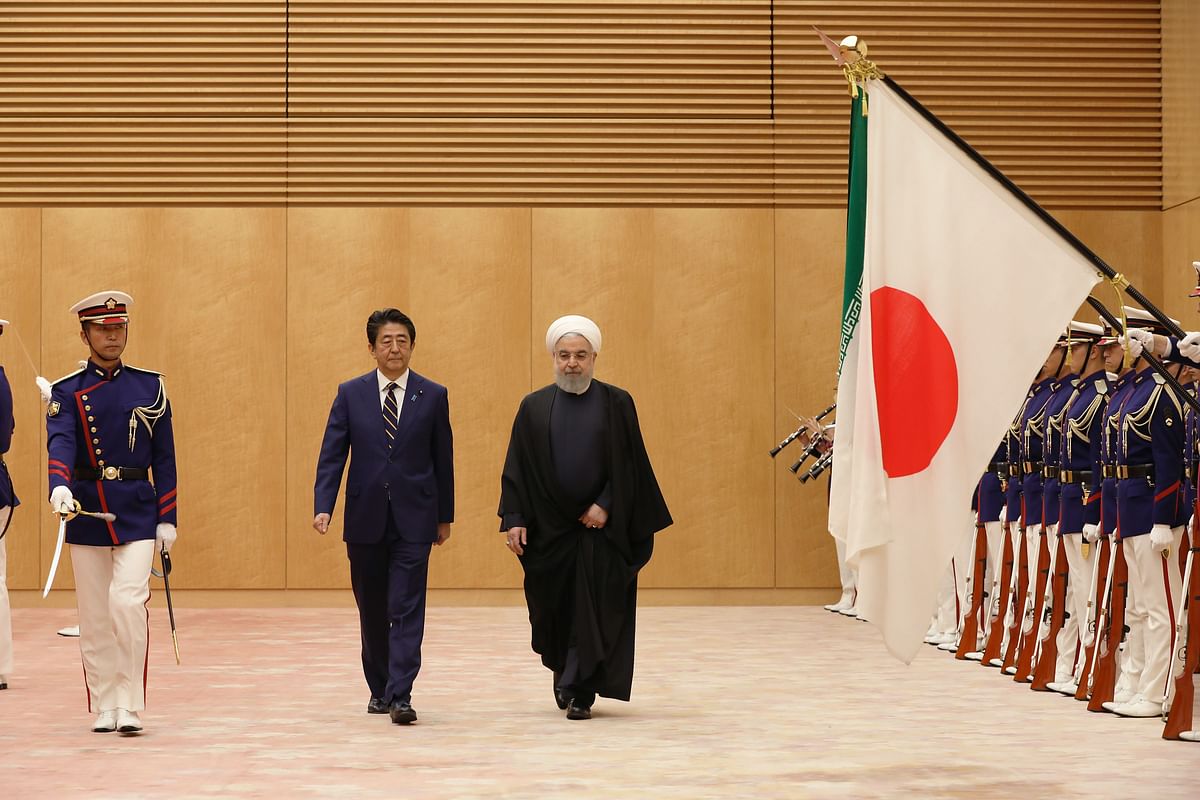 Japanese prime minister Shinzo Abe (centre L) and Iranian president Hassan Rouhani (centre R) review honour guards before a meeting in Tokyo on 20 December 2019. Photo: AFP