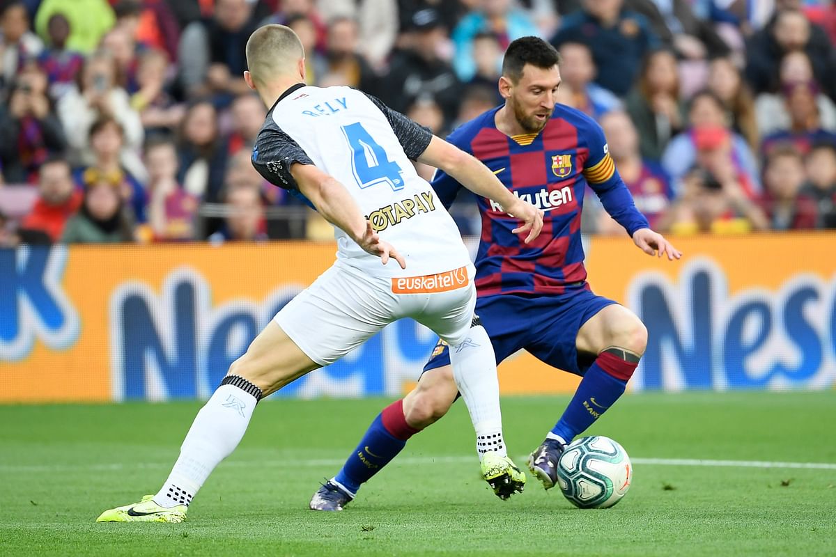 Alaves` Brazilian defender Rodrigo Ely (R) challenges Barcelona`s Argentine forward Lionel Messi during the Spanish league football match FC Barcelona against Deportivo Alaves at the Camp Nou stadium in Barcelona on 21 December 2019. Photo: AFP