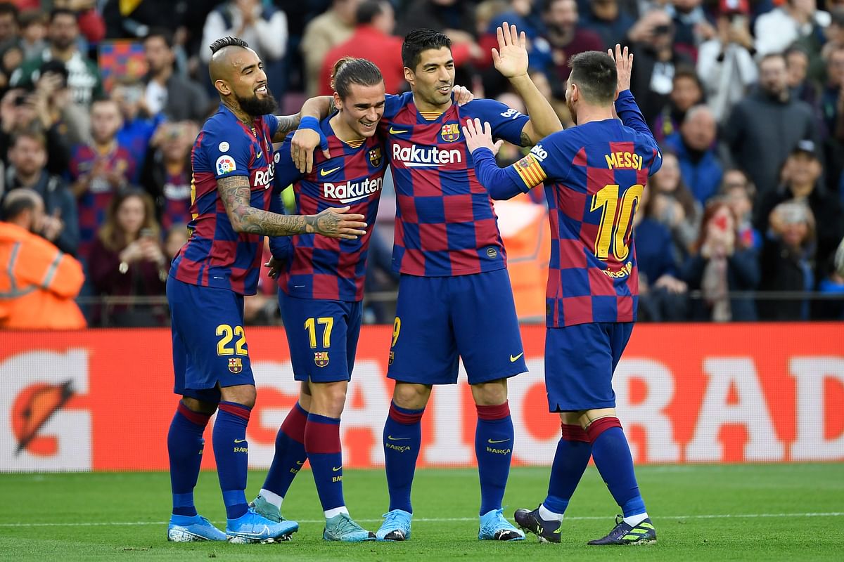 Barcelona`s French forward Antoine Griezmann (3R) celebrates with Barcelona`s Chilean midfielder Arturo Vidal, Barcelona`s Uruguayan forward Luis Suarez and Barcelona`s Argentine forward Lionel Messi after scoring a goal during the Spanish league football match FC Barcelona against Deportivo Alaves at the Camp Nou stadium in Barcelona on 21 December 2019. Photo: AFP