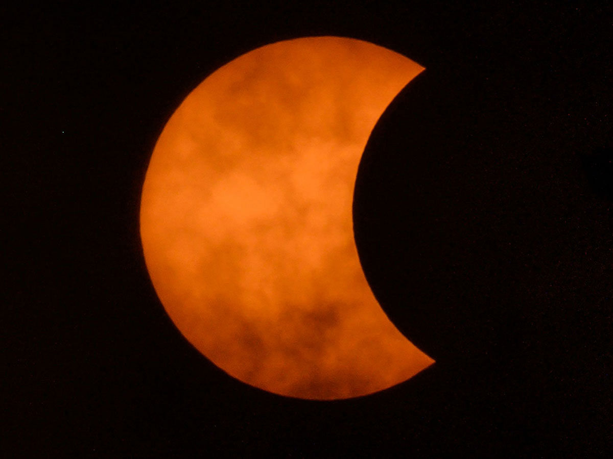 The moon moves in front of the sun in a rare `ring of fire` solar eclipse as seen from Bangkok on 26 December 2019. Photo: AFP