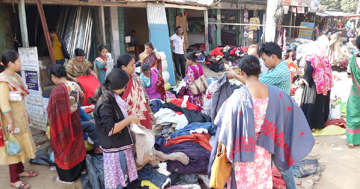 People buy warm clothes from a shop of old cloths in Rangamati. Photo: UNB