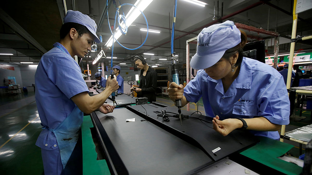 Employees work on the production line of a television factory under Zhaochi Group in Shenzhen, China on 8 August 2019. Reuters File Photo