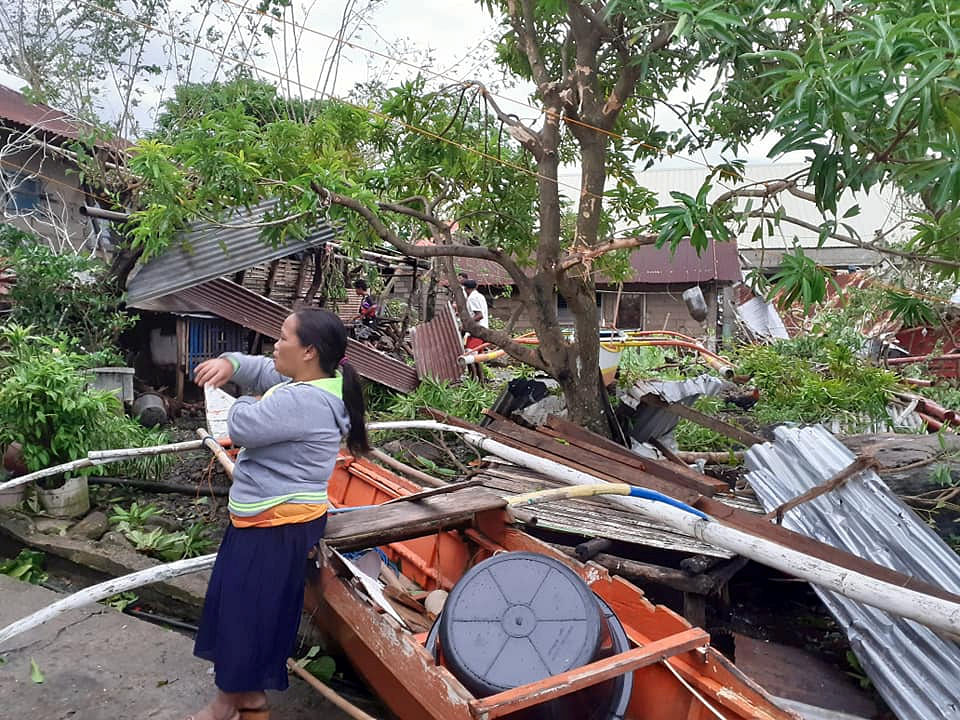 A woman is seen near storm debris in Biliran, Philippines on 26 December 2019. Photo: Reuters