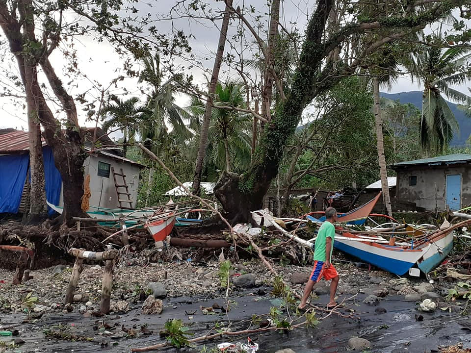 A man walks past storm debris in Biliran, Philippines on 26 December 2019. Photo: Reuters