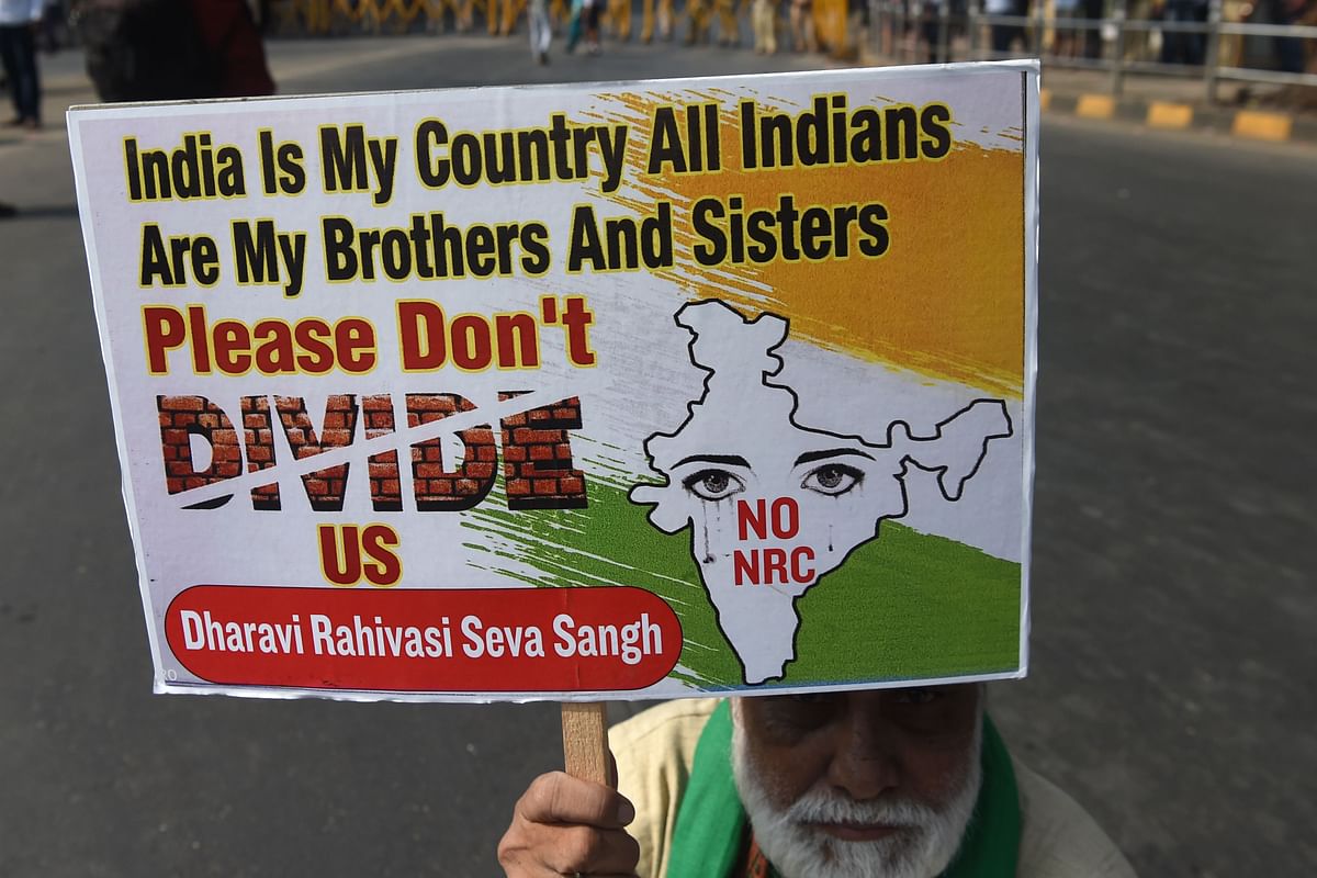 A protester holds a placard during a demonstration against India`s new citizenship law in Mumbai on 26 December 2019. The wave of protests across the country marks the biggest challenge to Modi`s government since sweeping to power in the world`s largest democracy in 2014. Photo: AFP
