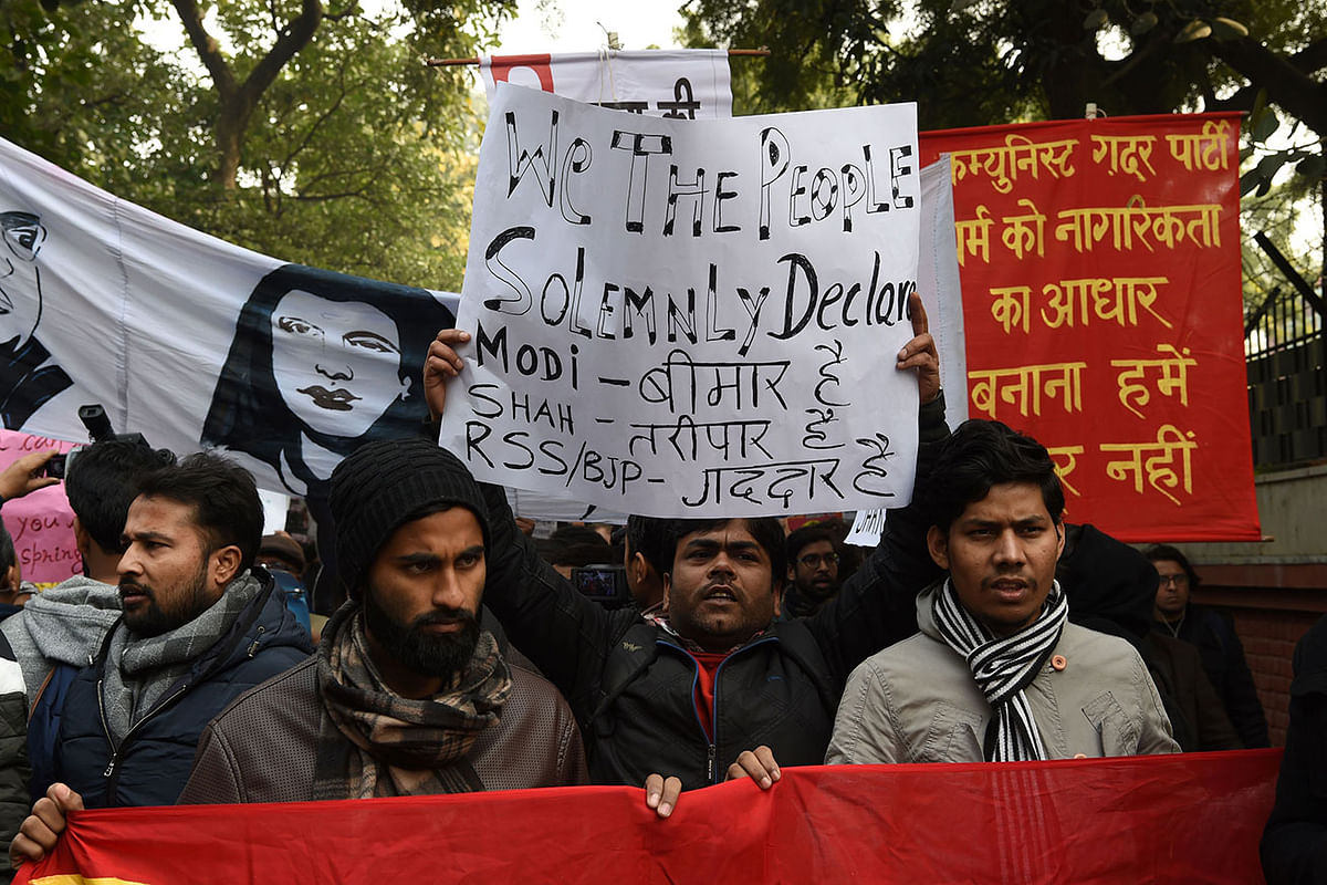 In this photo taken on 24 December 2019, protesters hold placards at a demonstration against India`s new citizenship law in New Delhi. Photo: AFP