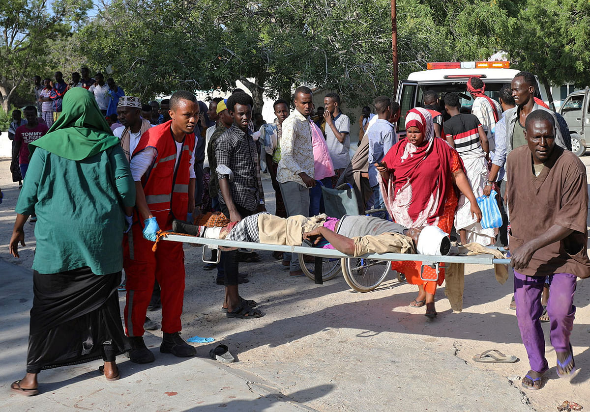 Paramedics and civilians assist a man injured in a car bomb explosion at a security checkpoint as he arrives to a hospital in Mogadishu, Somalia on 28 December 2019. Photo: Reuters
