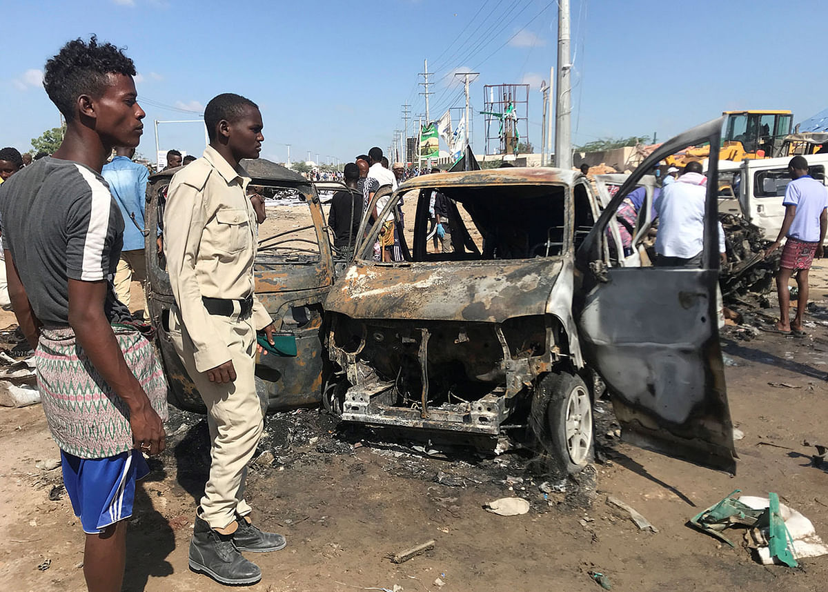 Somali security assess the scene of a car bomb explosion at a checkpoint in Mogadishu, Somalia on 28 December 2019. Photo: Reuters