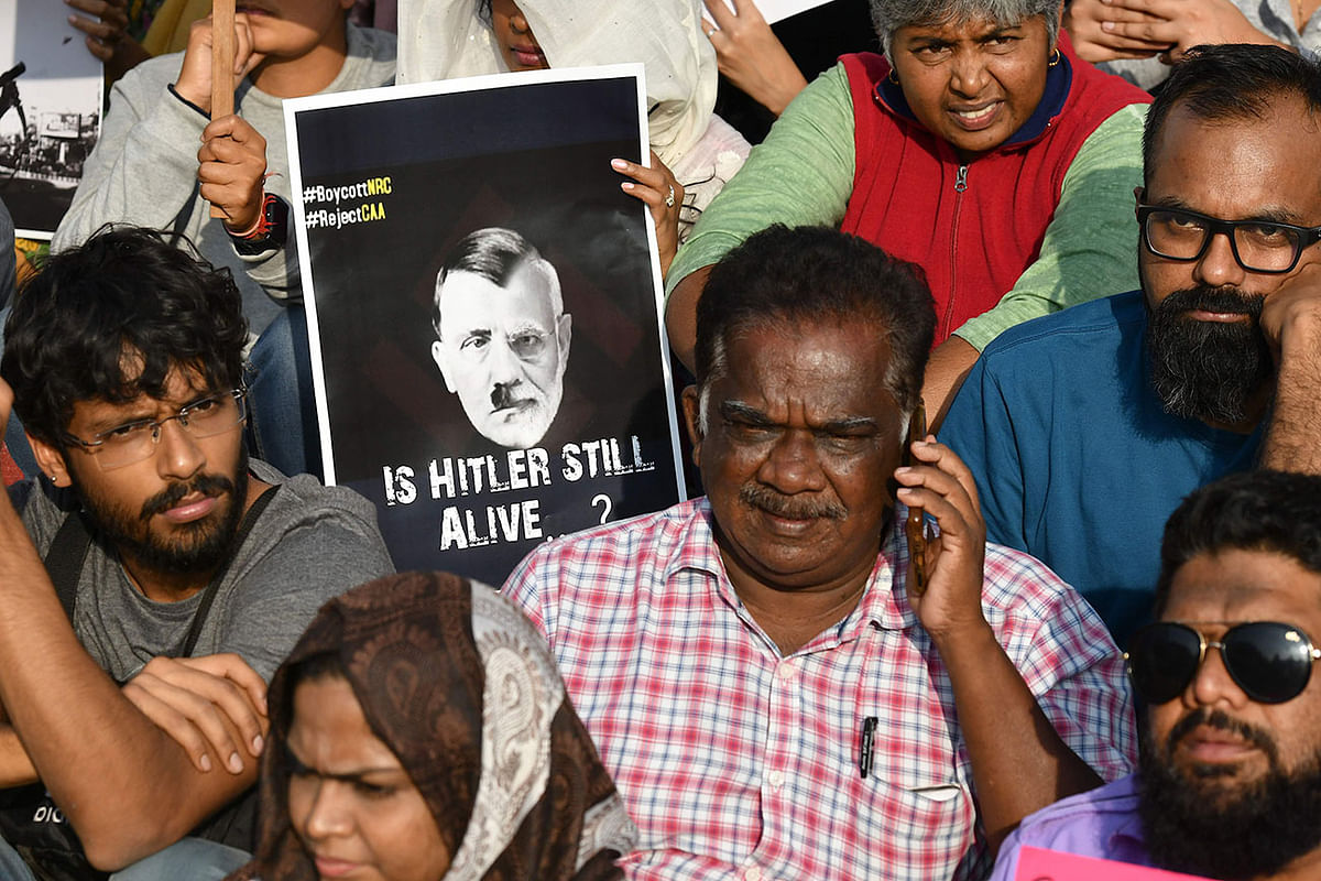In this file photo taken on 22 December 2019, a protester holds a placard comparing Indian prime minister Narendra Modi to German chancellor and Nazi Party leader Adolf Hitler during a demonstration held against India`s new citizenship law in Bangalore. Photo: AFP