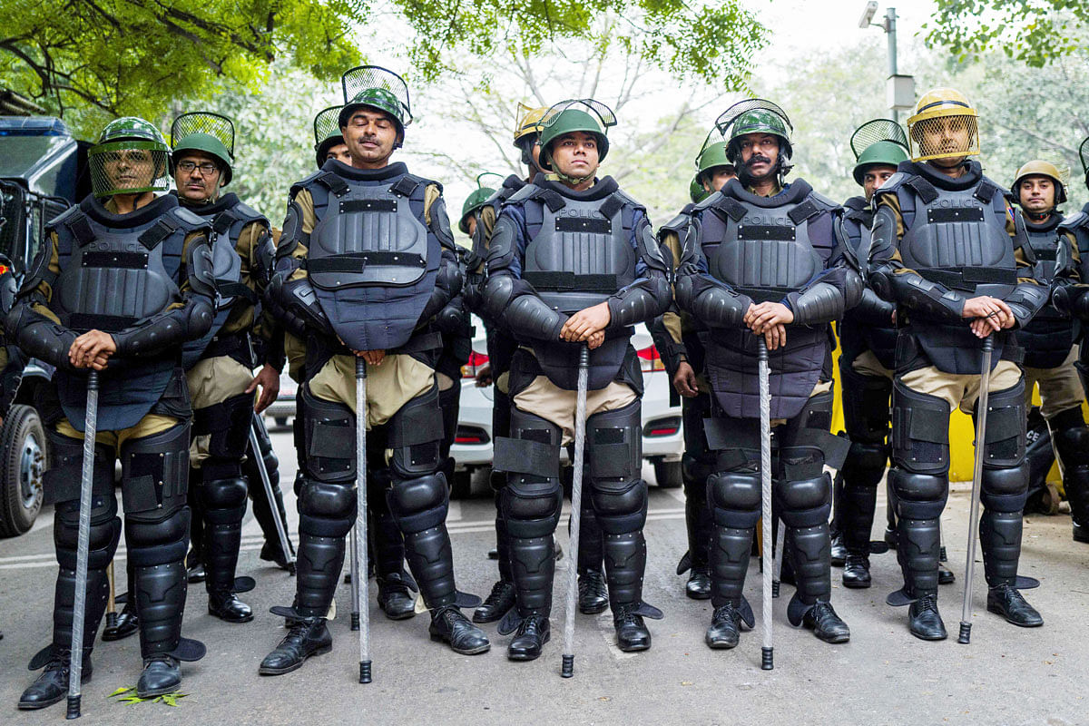 In this file picture taken on 16 December 2019, policemen armed with batons stand guard on a street as demonstrators take part in a protest against India`s new citizenship law in New Delhi. Photo: AFP
