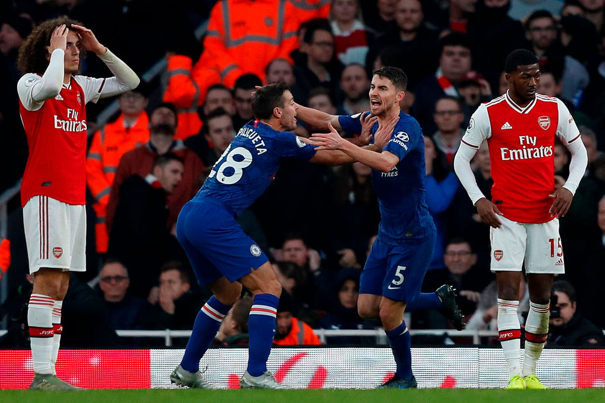 Chelsea`s Italian midfielder Jorginho (2R) celebrates scoring their first goal to equalise 1-1 with Chelsea`s Spanish defender Cesar Azpilicueta (2L) as Arsenal`s French midfielder Matteo Guendouzi (L) and Arsenal`s English midfielder Ainsley Maitland-Niles (R) react during the English Premier League football match between Arsenal and Chelsea at the Emirates Stadium in London on Sunday. Photo: AFP