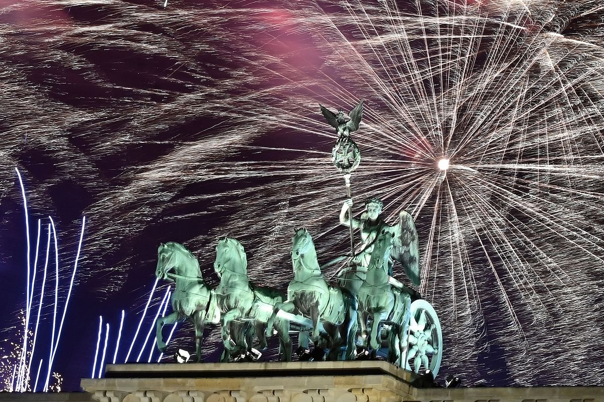 Fireworks explode behind the quadriga of Berlin`s landmark Brandenburg Gate to usher in the New Year on 1 January 2020. Photo: AFP
