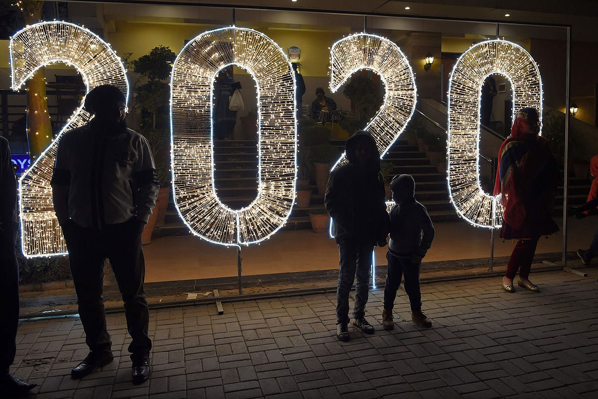 People stand in front of a `2020` sign as part of the New Year celebrations in Islamabad early on 1 January 2020. Photo: AFP