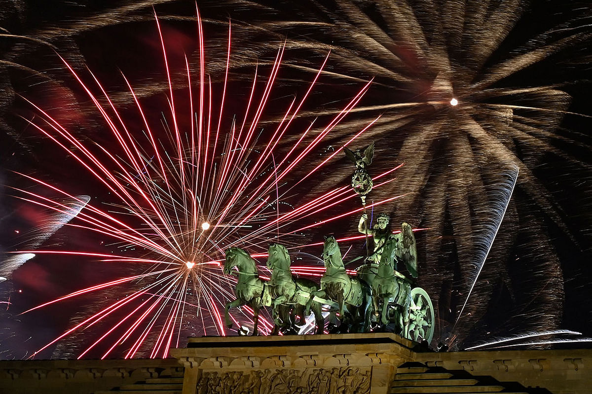 Fireworks explode behind the quadriga of Berlin`s landmark Brandenburg Gate to usher in the New Year on 1 January 2020. Photo: AFP