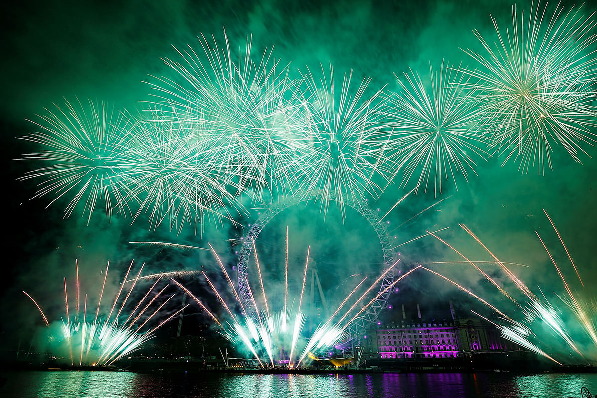 Fireworks explode over the London Eye wheel during New Year celebrations in central London. Photo: Reuters