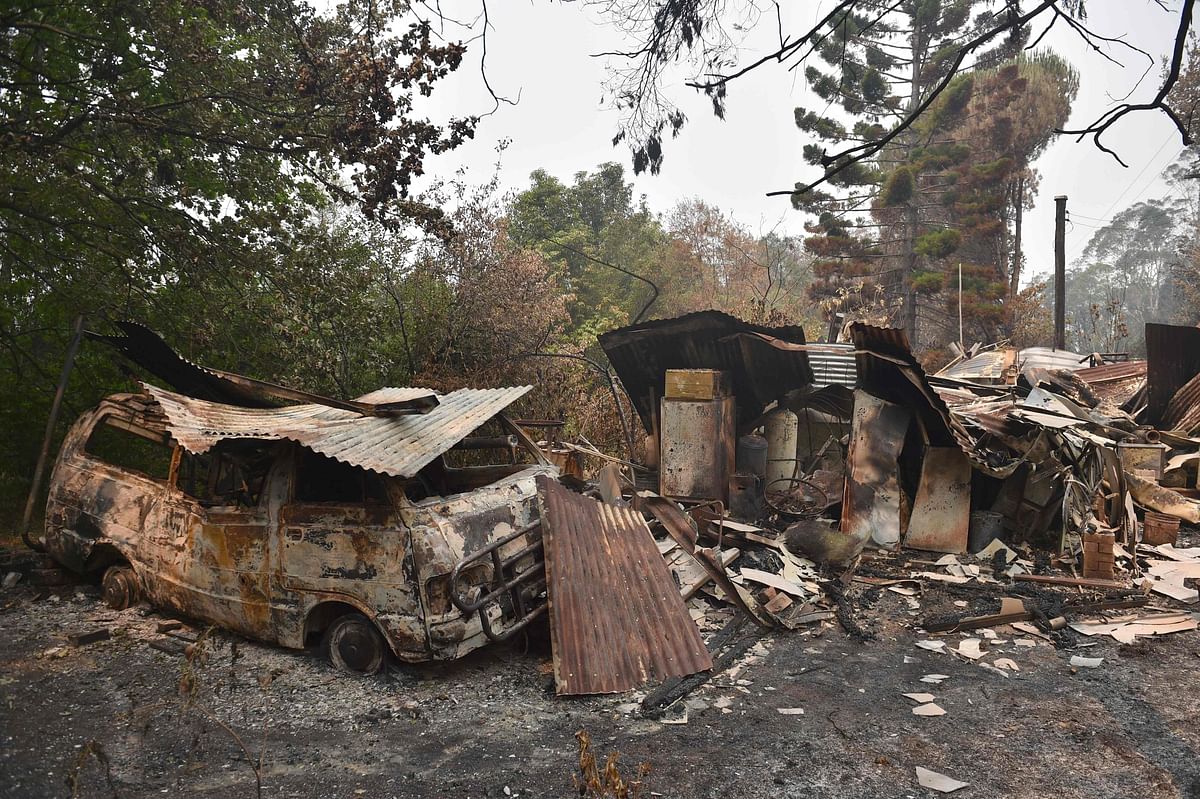 A house and van are seen destroyed after bushfires ravaged the town of Bilpin, 70km west of Sydney on 29 December 2019. Photo: AFP