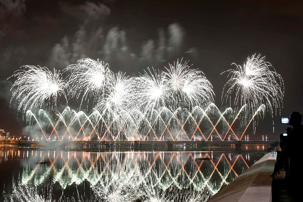 Fireworks light up the sky over the General de Gaulle bridge and the Ebrie lagoon during New Year`s celebrations in Abidjan early on 1 January 2020. Photo: AFP